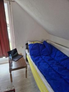 a bedroom with a bed and a table with a laptop at Mountain Home Paravci in Čajniče