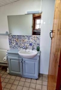 a bathroom with a sink and a mirror at Cottage Skelligs Coast, Ring of Kerry in Cahersiveen