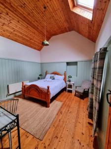 a bedroom with a bed and a wooden ceiling at Cottage Skelligs Coast, Ring of Kerry in Cahersiveen