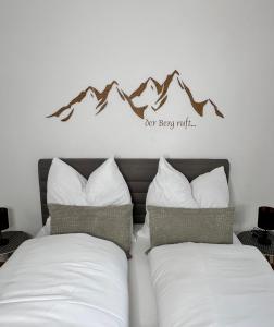 Postel nebo postele na pokoji v ubytování Grimming Lodge Tauplitz