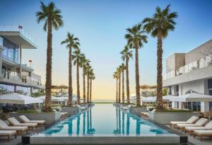 a resort with palm trees and a swimming pool at FIVE Palm Residences in Dubai