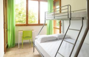 a bedroom with a bunk bed with a desk and a chair at Safestay Pisa Centrale in Pisa