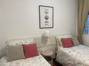 a bedroom with two beds and a lamp next to a window at Laguna center in Fuengirola