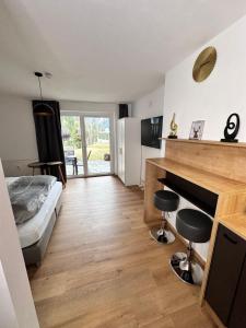 a bedroom with a bed and a desk with two stools at Grimming Lodge Tauplitz in Tauplitz