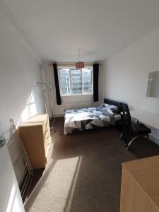 a bedroom with a bed and a window at Private rooms with shared facilities in Camden Town in London