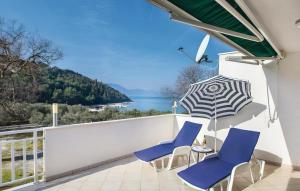 a balcony with two chairs and an umbrella at Apartman Vesna in Opuzen