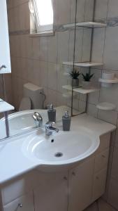 a bathroom with a white sink and a tub at Apartman Vesna in Opuzen +17 photos