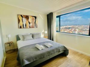 a bedroom with a bed and a large window at Vila Pombal Tomar Apartments - Pool & City Views in Tomar