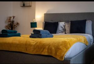 a bedroom with a large bed with a yellow blanket at Cozy Roome @ Wallsend B in Old Walker