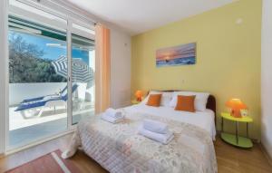 a bedroom with a bed and a view of the ocean at Apartman Vesna in Opuzen