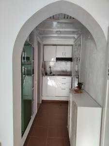 a small kitchen with an archway in a room at Domina Coral Bay in Sharm El Sheikh