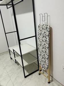 ein Regal in einem Zimmer mit einem Kühlschrank in der Unterkunft Casa de praia 6km Beto Carrero - Praia Gravatá in Navegantes