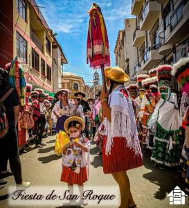 a group of people walking down a street in a parade at Departamento Rustico 1 in Tarija
