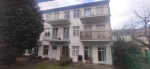 a white apartment building with balconies on it at Altstadt Kiek mal wedder in in Wismar