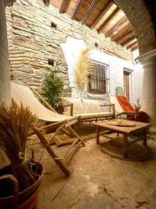 a living room with a couch and a table and chairs at Arcos de Tarifa, Casco historico in Tarifa