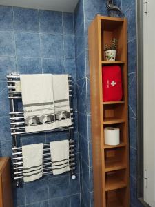 a towel rack with towels on it in a bathroom at Euforbia House in Lido di Ostia