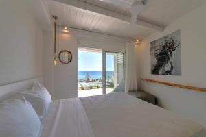 a bedroom with a bed and a view of the ocean at Villa Sávra in Plakias +34 photos
