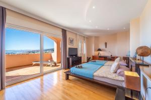 a bedroom with a large bed and a large window at Beachside villa with panoramic sea views in Benalmádena +42 photos