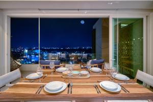 a dining room table with a view of the city at Luxurious Penthouse in Puerto Vallarta in Puerto Vallarta