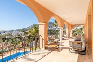 a house with a balcony with a view at Beachside villa with panoramic sea views in Benalmádena