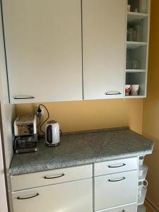 a kitchen with white cabinets and a counter top at Wohnung Michael Lust auf Zuhause Ferien in der Provinz in Herford