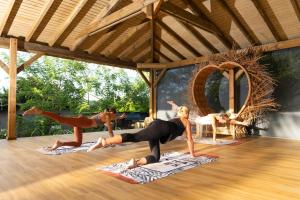 two women in a yoga class in a pavilion at Luxe pleine vue mer et plage in Saint-François