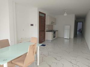 a kitchen with a table and chairs in a room at Poppy Court in Marsaskala