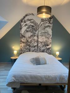 a bedroom with a large bed with a wall at Petit Coin du Port in Ploubazlanec