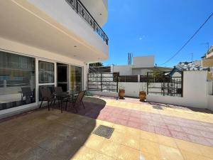 a balcony of a house with a table and chairs at Azzurro in Paleros