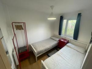 a room with two beds and a window at Woodland bungalow, fantastic location in Uny Lelant
