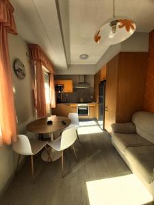 a kitchen and living room with a table and chairs at Novama in O Grove