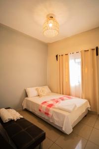 a bedroom with a bed and a chandelier at Cozy Renting Hospedaje in Santa Rosa de Copán