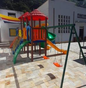 a playground with a slide and a swing at Casa Do Roger Hospedagem in Ouro Preto