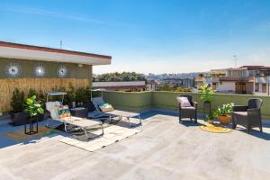 a patio with chairs and tables on a roof at Medea home in Catania