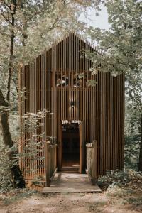a wooden building with a door in a forest at Cabane de la Saône by Lyon Country House in Caluire-et-Cuire