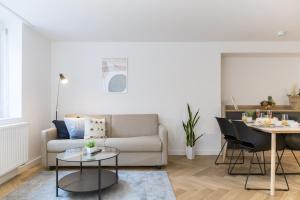 a living room with a couch and a table at Adler Apartments Sasbachwalden in Sasbachwalden