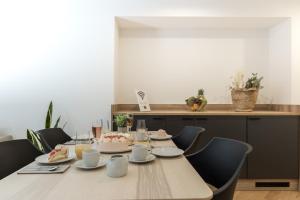 a dining room table with a cake on top of it at Adler Apartments Sasbachwalden in Sasbachwalden