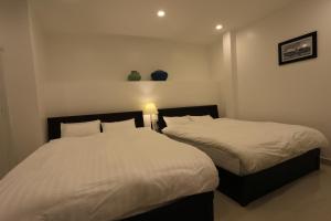 Postel nebo postele na pokoji v ubytování Xuan Cuong Hotel