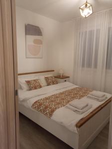 a bedroom with a large bed in a room at Bella in Sremska Mitrovica