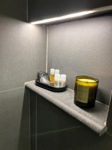 una mensola in bagno con una candela di Maison Santa Lucia a Napoli