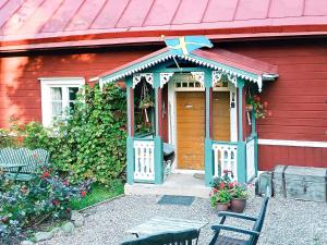 a red house with a gazebo on it at Holiday home Mantorp in Mantorp