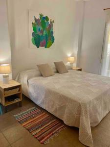 a bedroom with a bed with two pillows on it at El Toyo Cactus in Almería