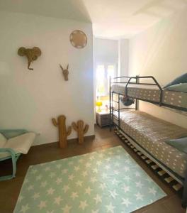 a room with two bunk beds and a rug at El Toyo Cactus in Almería