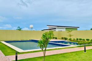 a swimming pool in the yard of a house at Plumera Condo Near Mactan Airport, Mall and School in Lapu Lapu City