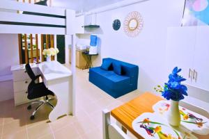 a room with a bed and a desk and a chair at Plumera Condo Near Mactan Airport, Mall and School in Lapu Lapu City