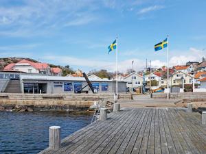 two flags flying over a harbor with a town at 6 person holiday home in LYSEKIL-By Traum in Lysekil