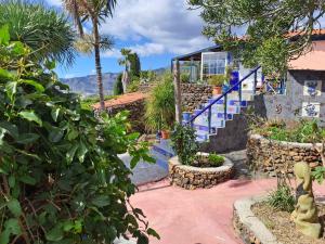 a house with a blue staircase and some plants at Casa Mosaico, sunset and garden in Los Llanos de Aridane