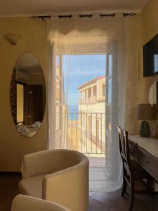 a living room with a chair and a large window at B&B Rivellini in Tropea