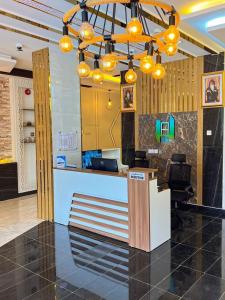 an office with a reception desk and lights at Alhamra Horizons in Al Ḩamrāʼ