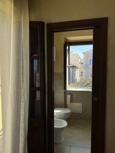a bathroom with a toilet and a window at B&B Rivellini in Tropea